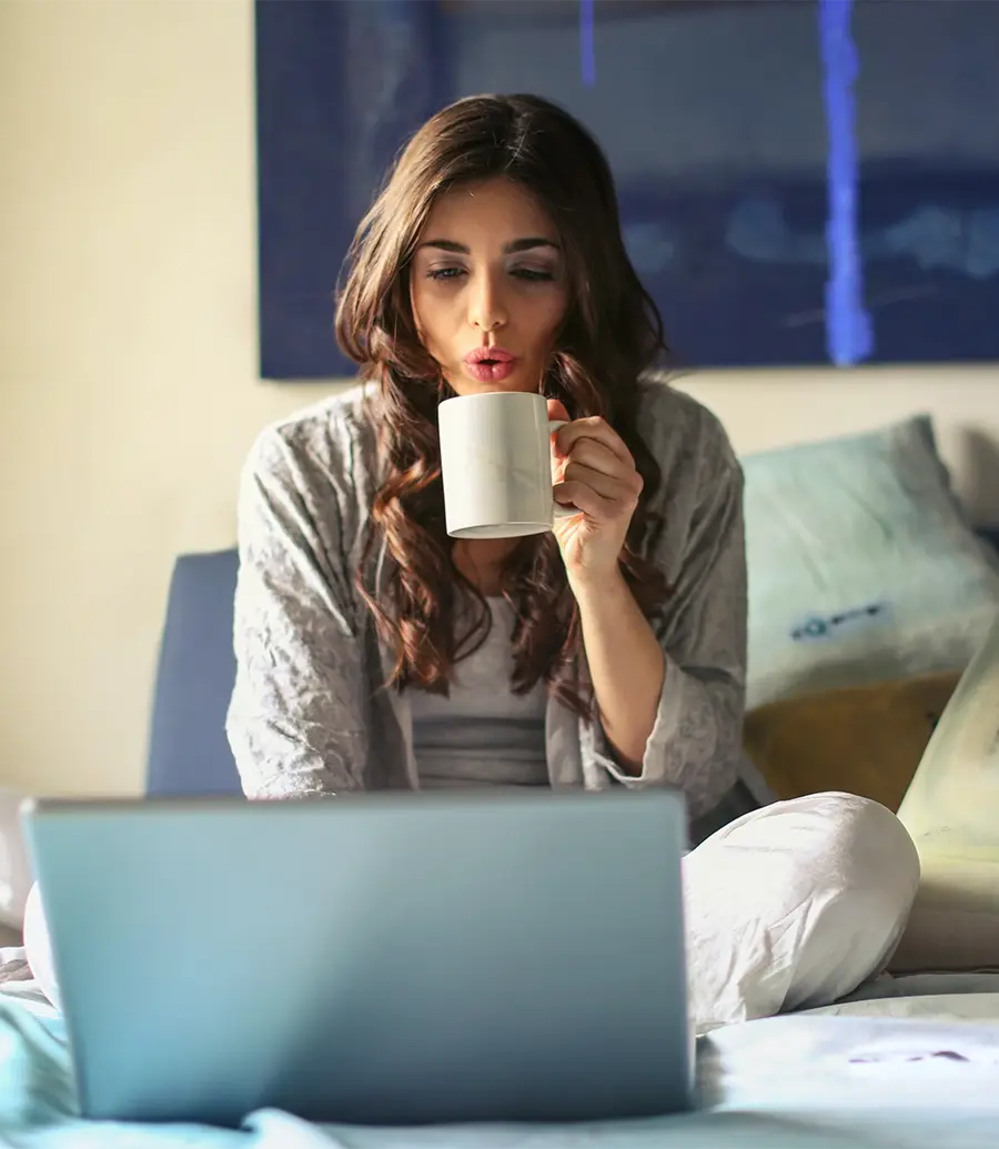 Woman drinking coffee in bed